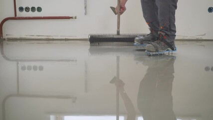 Poster - Master with a needle roller. Filling the floor. A contractor painter will paint the garage floor to speed up the sale of your home. Floor screed filling, repair and finishing. Fill in the low spots