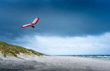 Hang Glider Soars On The Beach