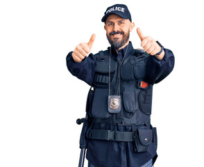 Poster - Young handsome man wearing police uniform approving doing positive gesture with hand, thumbs up smiling and happy for success. winner gesture.