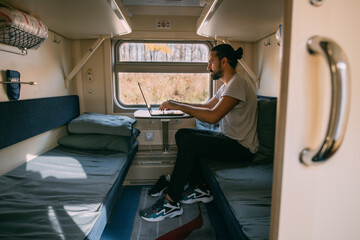 Wall Mural - Man with laptop on the train.