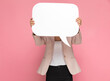 © Viorel Sima - businesswoman hiding behind a speech bubble