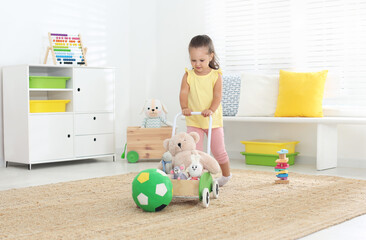 Poster - Cute little girl playing with toy walker at home