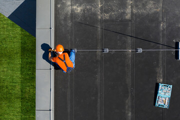 Technician Installing Lightning Protection Rod on Top of Building