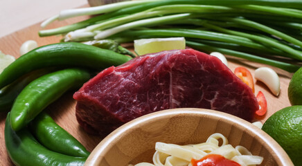 making pho bo vietnamese soup. serving of soup in a white plate. view from above. Fresh natural ingredients.