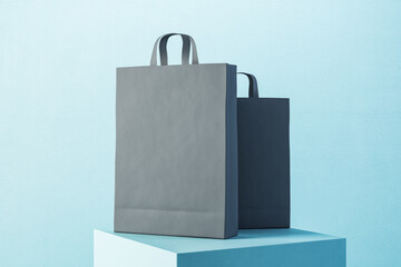 Poster - Two black paper shopping bag with handles on blue podium.