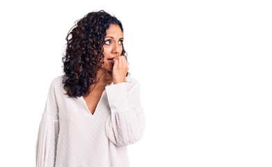 Wall Mural - Middle age beautiful woman wearing casual sweater looking stressed and nervous with hands on mouth biting nails. anxiety problem.