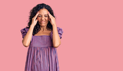 Wall Mural - Middle age beautiful woman wearing casual dress suffering from headache desperate and stressed because pain and migraine. hands on head.