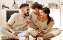 Happy Multiethnic Family Mom, Dad And Child  Laughing, Playing And Tickles    On Floor In Cozy Kitchen At Home.