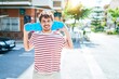 © Krakenimages.com - Young caucasian skater man smiling happy holding skate walking at street of city.