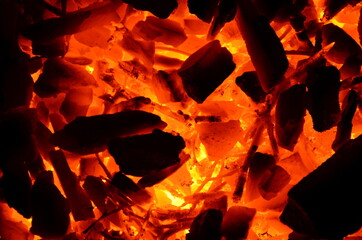 Poster - Coarse anthracite coal flares up from wood as a background.
