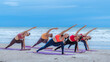 Team asian young healthy woman posing practice yoga on the beach at with blue cloud sky background in healthy exercise lifestyle concept