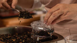Fototapeta  - close up of a woman making a tea blend