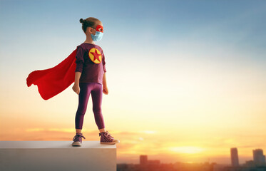 Wall Mural - Little child playing superhero and wearing face mask