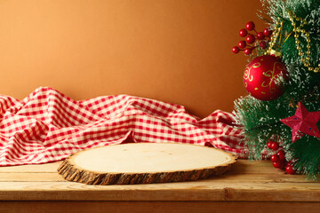 Poster - Empty wooden log board on rustic table with Christmas tree and red checked tablecloth. Christmas background for mock up design