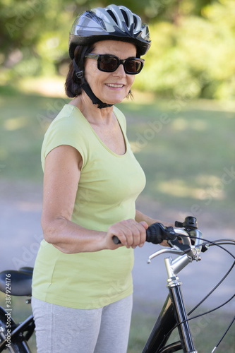 portrait of senior woman 60-65 years old on bicycle