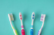 Clean toothbrushes of different colors on a blue background