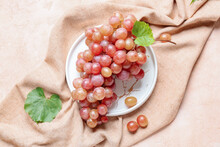 Plate With Sweet Ripe Grapes On Color Background