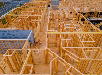 Aerial view of unfinished house with wooden beam house construction development