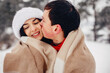 © prostooleh - Young couple in a winter park. Man with a red sharf. Lady in a red jacket