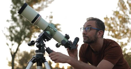 Wall Mural - amateur astronomer looking at the stars with a telescope.