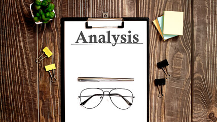 Poster - ANALYSIS text form on a wooden table.