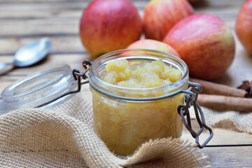 close on homemade compote  in a glass  jar with red apples  background