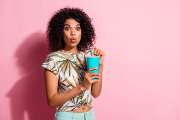 Wall Mural - Photo portrait of shocked woman holding plastic straw paper cup in hands isolated on pastel pink colored background with blank space