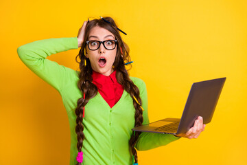 Sticker - Portrait of attractive funky amazed genius girl holding in hands laptop academic year isolated over bright yellow color background