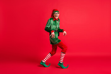 Wall Mural - Full body profile side photo of crazy naughty elf sneak x-mas copyspace wear christmas headwear isolated on shine color background