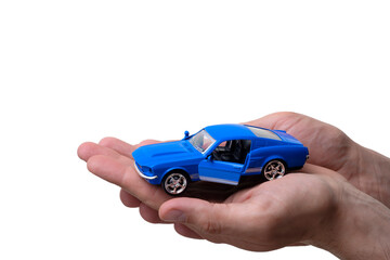 Hands holding a toy car as a dream concept of buying a car