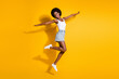 © deagreez - Full length body size view of pretty slim cheerful wavy-haired girl jumping having fun isolated over bright yellow color background