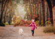 © tan4ikk - Little girl with dog running into forest