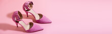 pair of elegant suede heeled shoes on pink background, banner