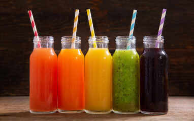 Sticker - bottles of fruit juice on a wooden table