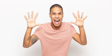 Wall Mural - young black man screaming in panic or anger, shocked, terrified or furious, with hands next to head