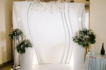 Decorated wedding arch in winter with fur tree branches. Christmas winter wedding. Event. Photo-wall, decoration space or place.