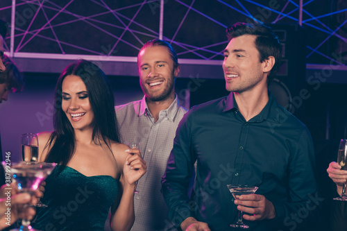 Photo portrait of two guys thinking to approach girls at nightclub holding together cocktail glasses