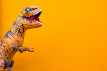 One Big And Tall Dinosaur Enjoying And Having Fun With Orange Background - Copy And Blank Space To Write Your Text Here