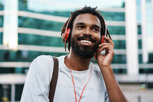 Cheerful African American Guy Listening Music With Headphones