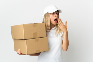 ¬°Young delivery woman isolated on white background yawning and covering wide open mouth with hand