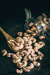 Wall Mural - Raw unpeeled cashew nuts on a dark background