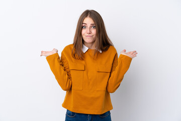 Wall Mural - Young woman over isolated white background having doubts while raising hands