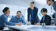 © Gorodenkoff - Busy Diverse Team of Computer Engineers and Specialists Gather Around Conference Table, They Discuss Project Drafts and Blueprints, Find Problem Solutions. Industrial Technology Office Meeting Room