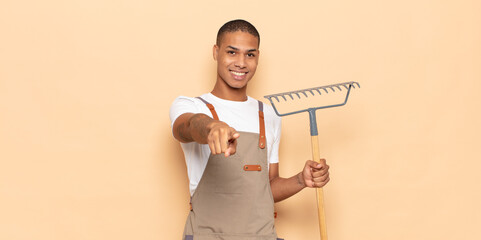 Sticker - young black man pointing at camera with a satisfied, confident, friendly smile, choosing you