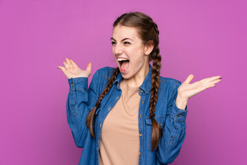 Wall Mural - Young woman over isolated purple background with surprise facial expression