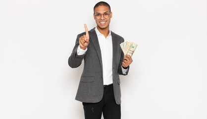 Sticker - young black man smiling and looking friendly, showing number one or first with hand forward, counting down