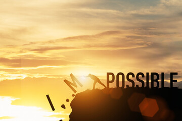 Wall Mural - Businessman push impossible wording to possible wording on top of mountain with sunlight. Positive mindset concept.