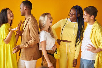 stylish trendy mixed race youth talking, smiling isolated on yellow background, people diversity concept