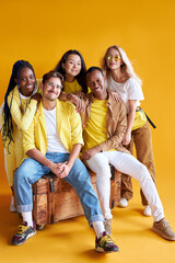 group of multiethnic friends, people of different cultures isolated on yellow background, good-looking men and women in stylish wear posing, students in one country