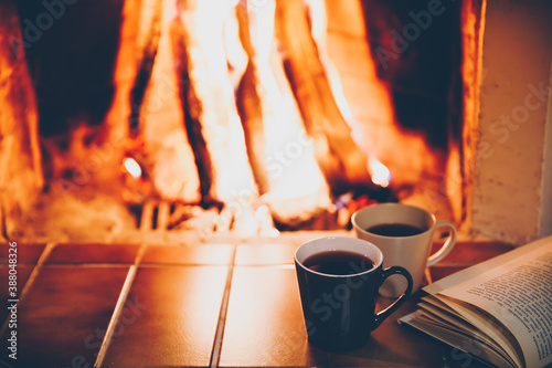 Cuadros en Lienzo Two cups and Open book by Fireplace